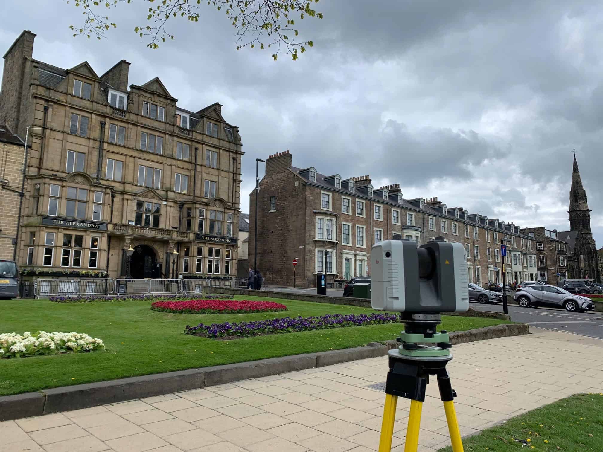 High precision laser scanner set up in a historic city square for detailed 3D mapping and surveying.